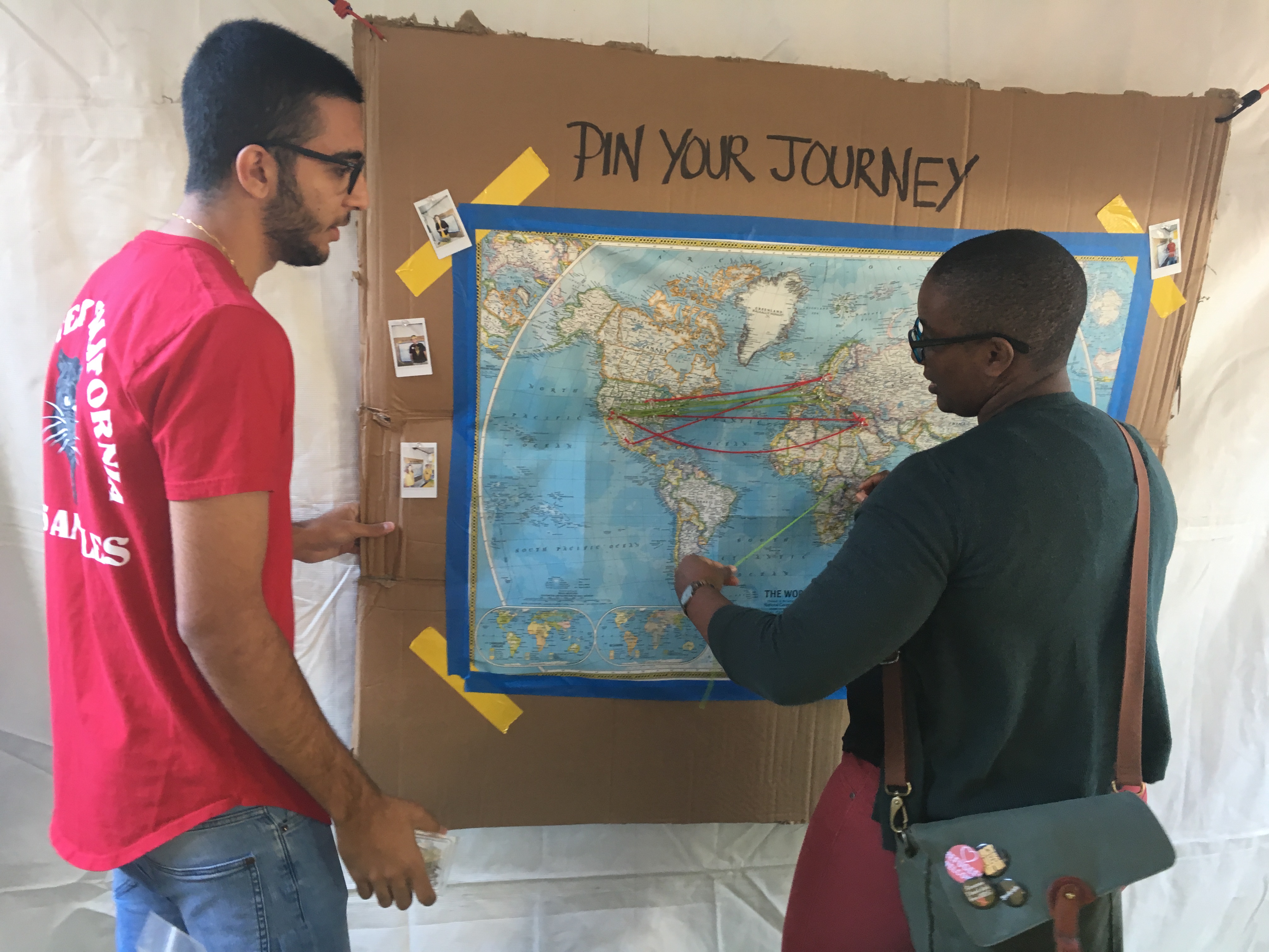 Two people working on a "pin your journey" map.