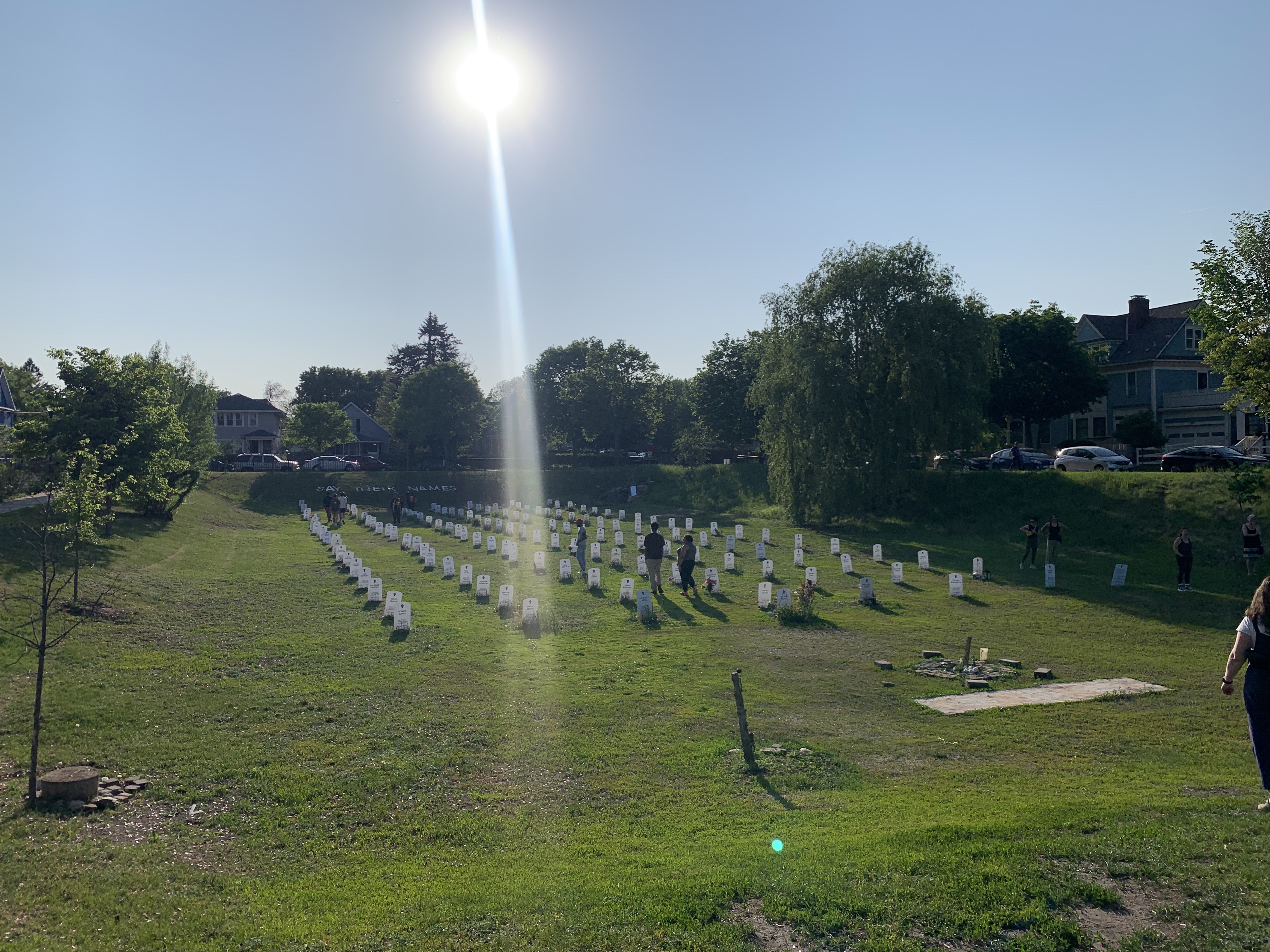 Image of a field filled with white headstones.