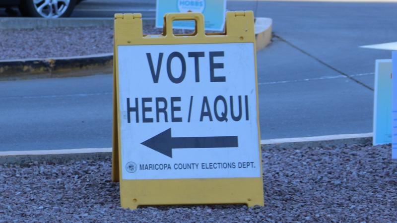 A sign that reads "VOTE HERE/AQUI"
