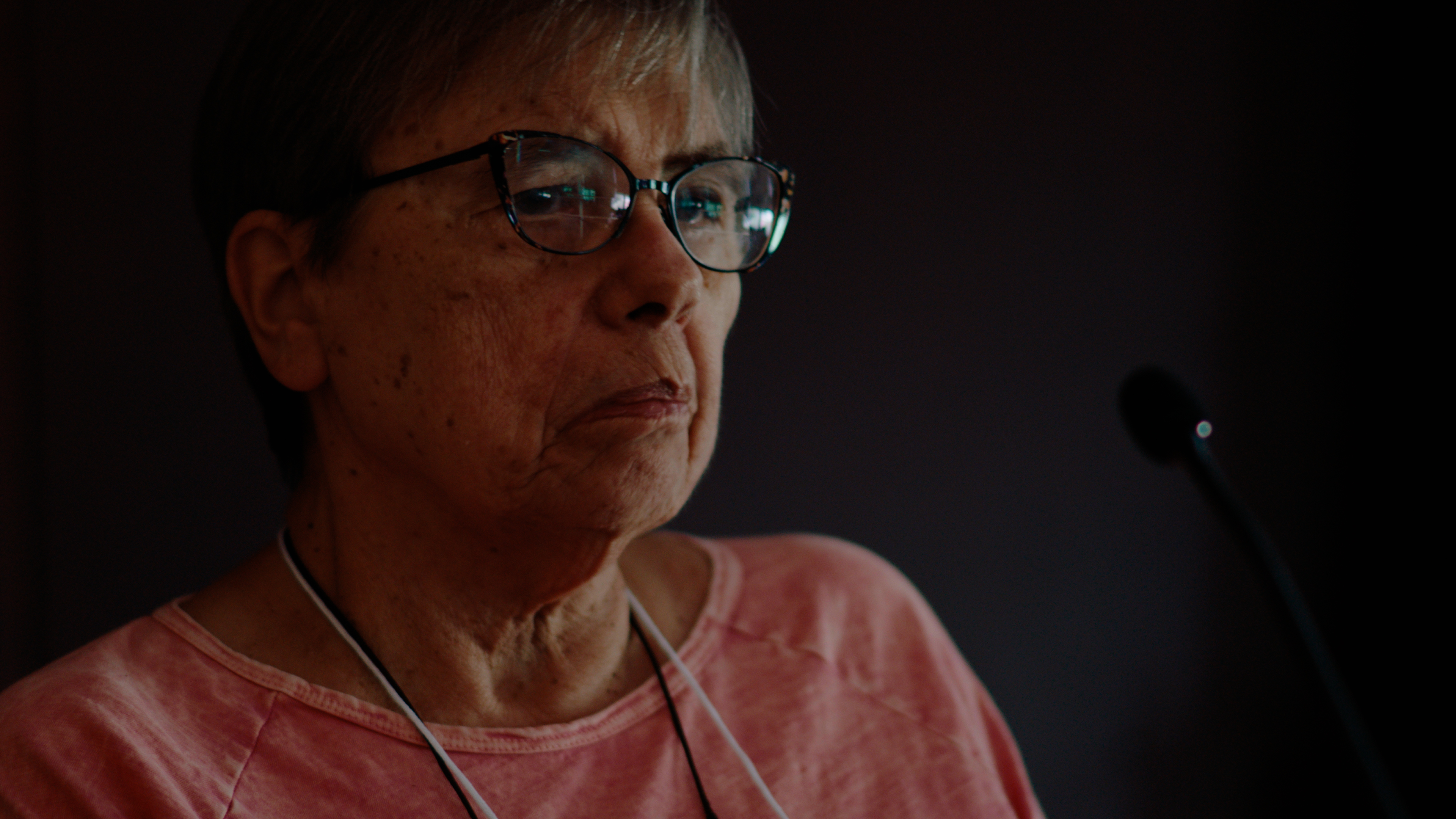 Mary Margaret, in dramatic lighting, listens intently.