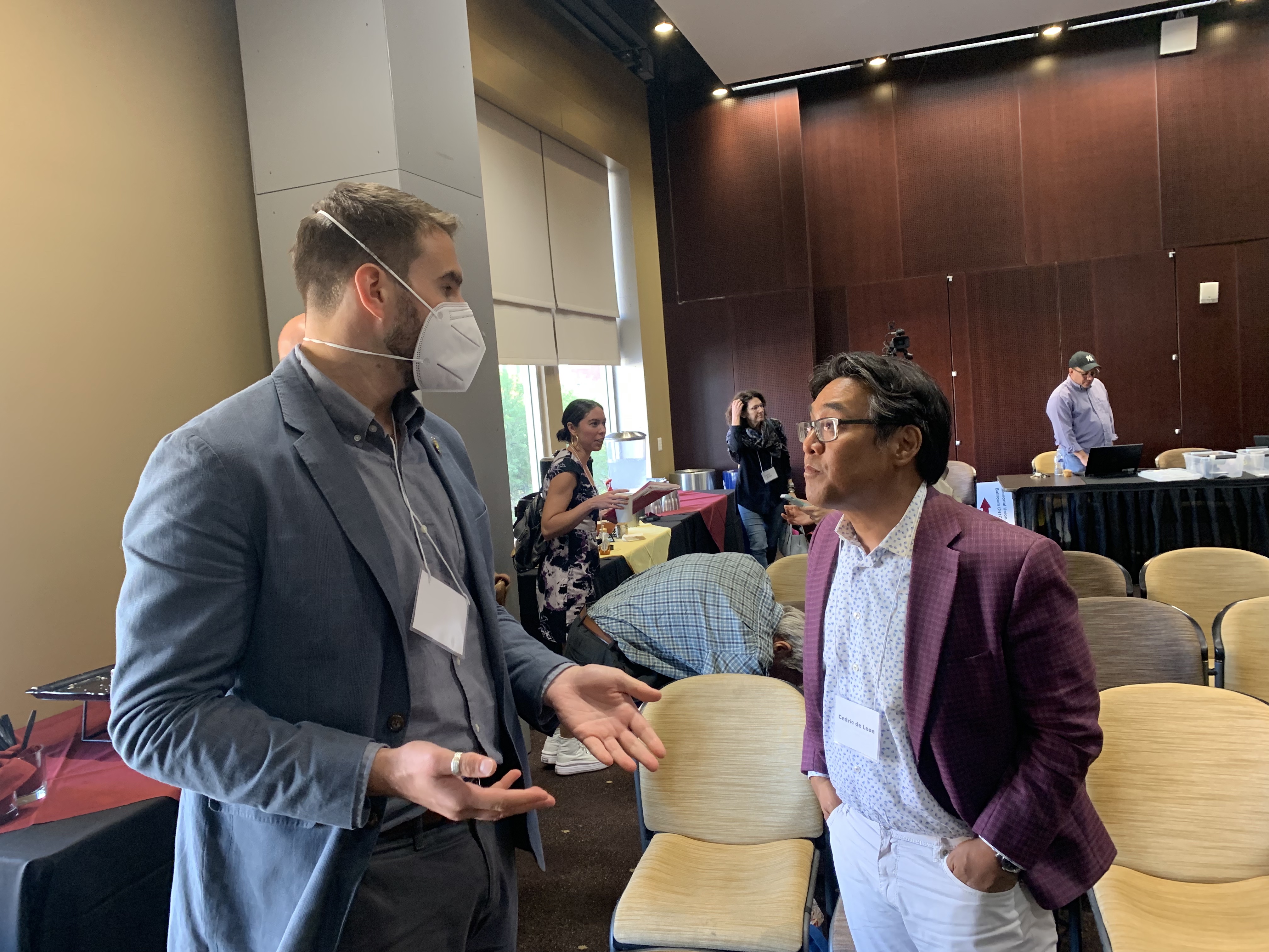 Two gentlemen speak after the conference.