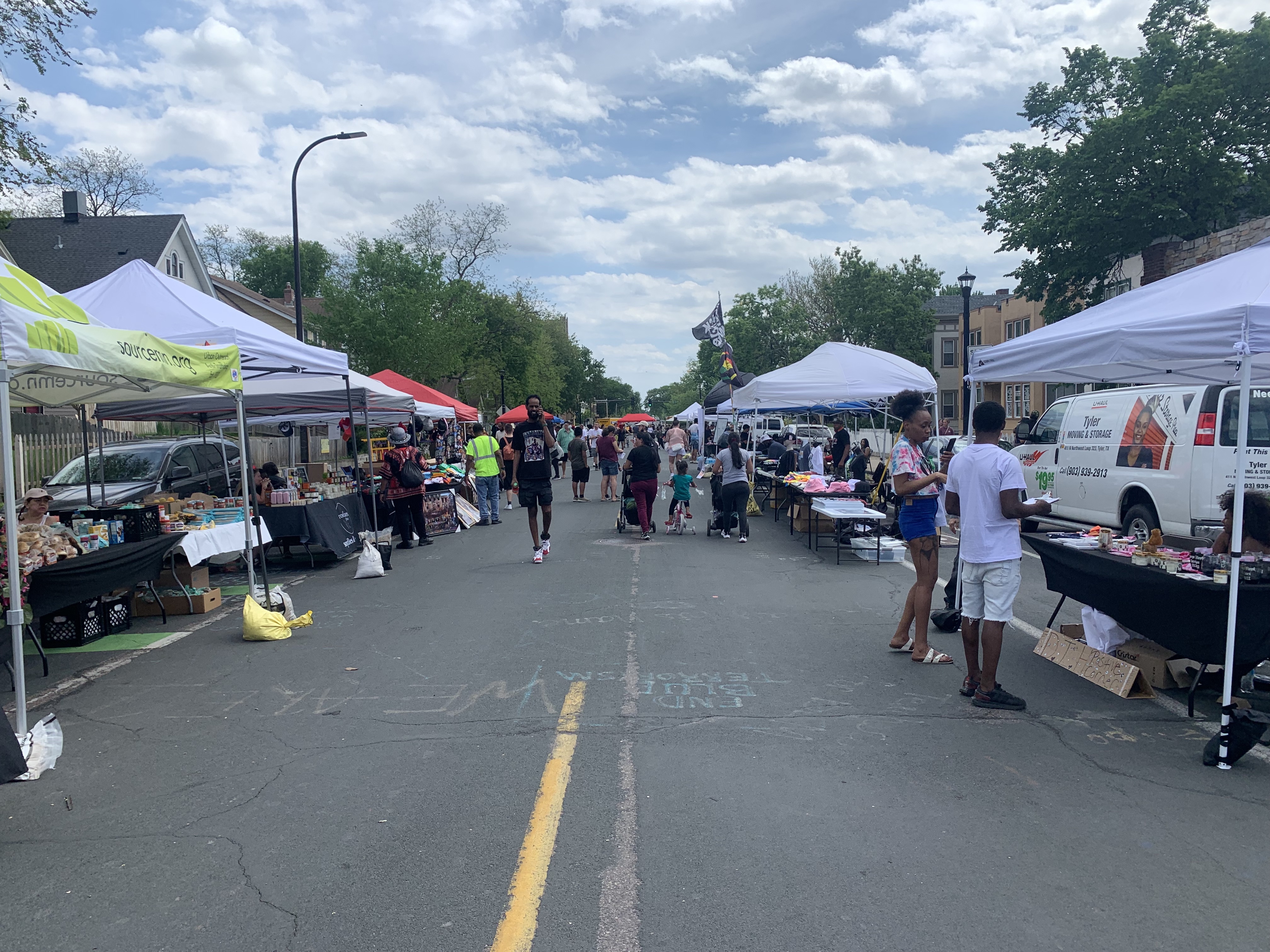 Vendors lining a street.