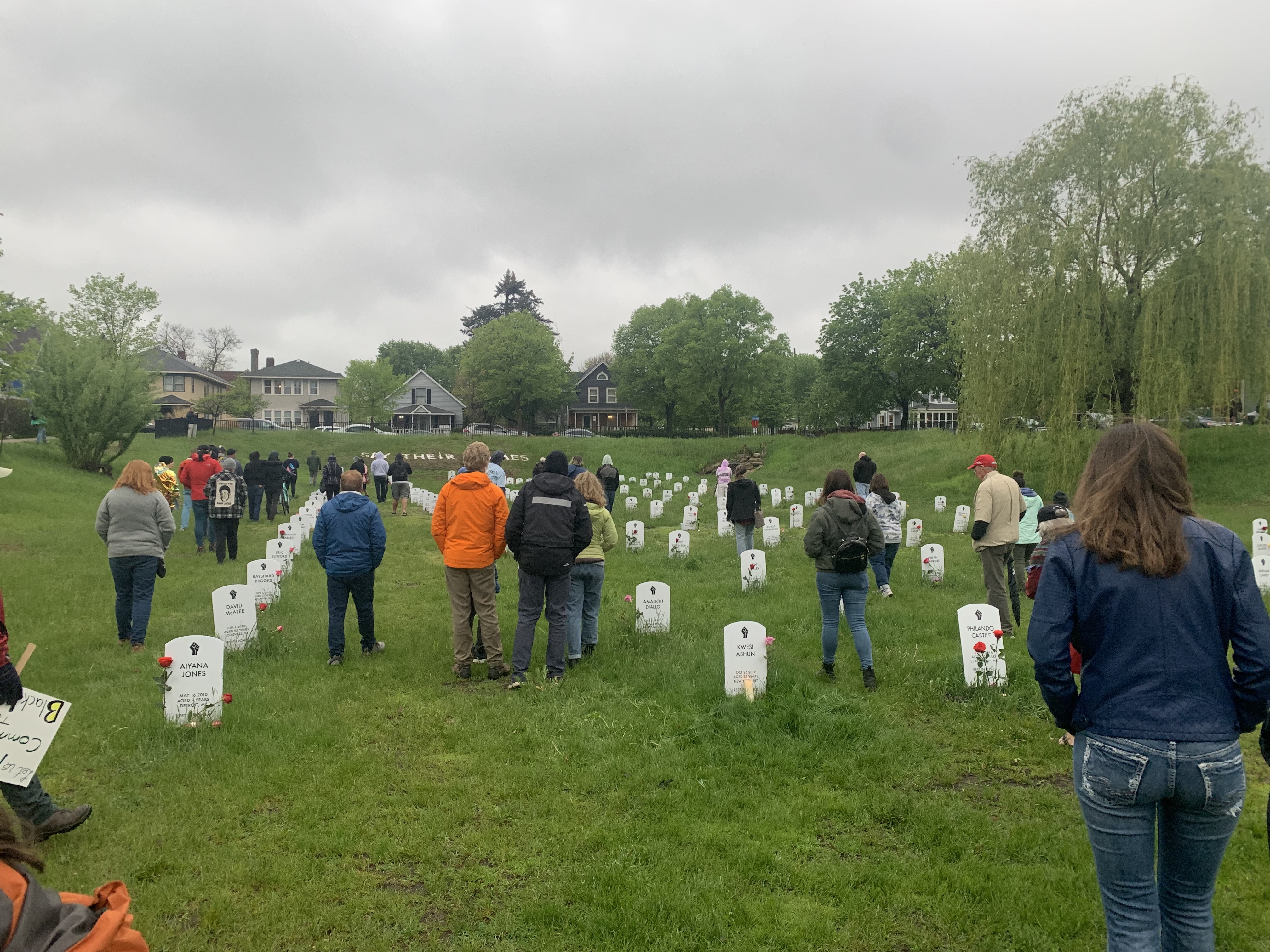 People walk in a cemetary.