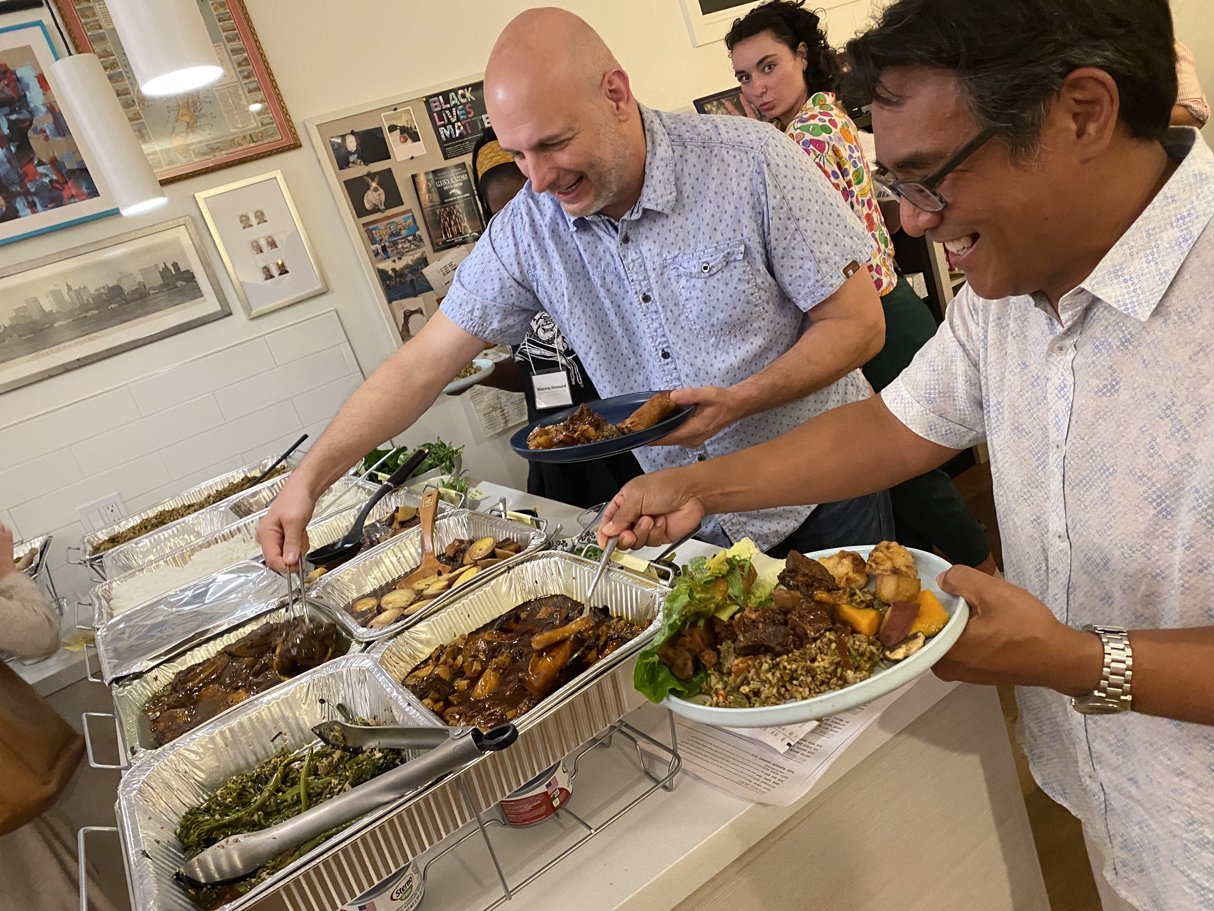 Two men at a dinner buffet.