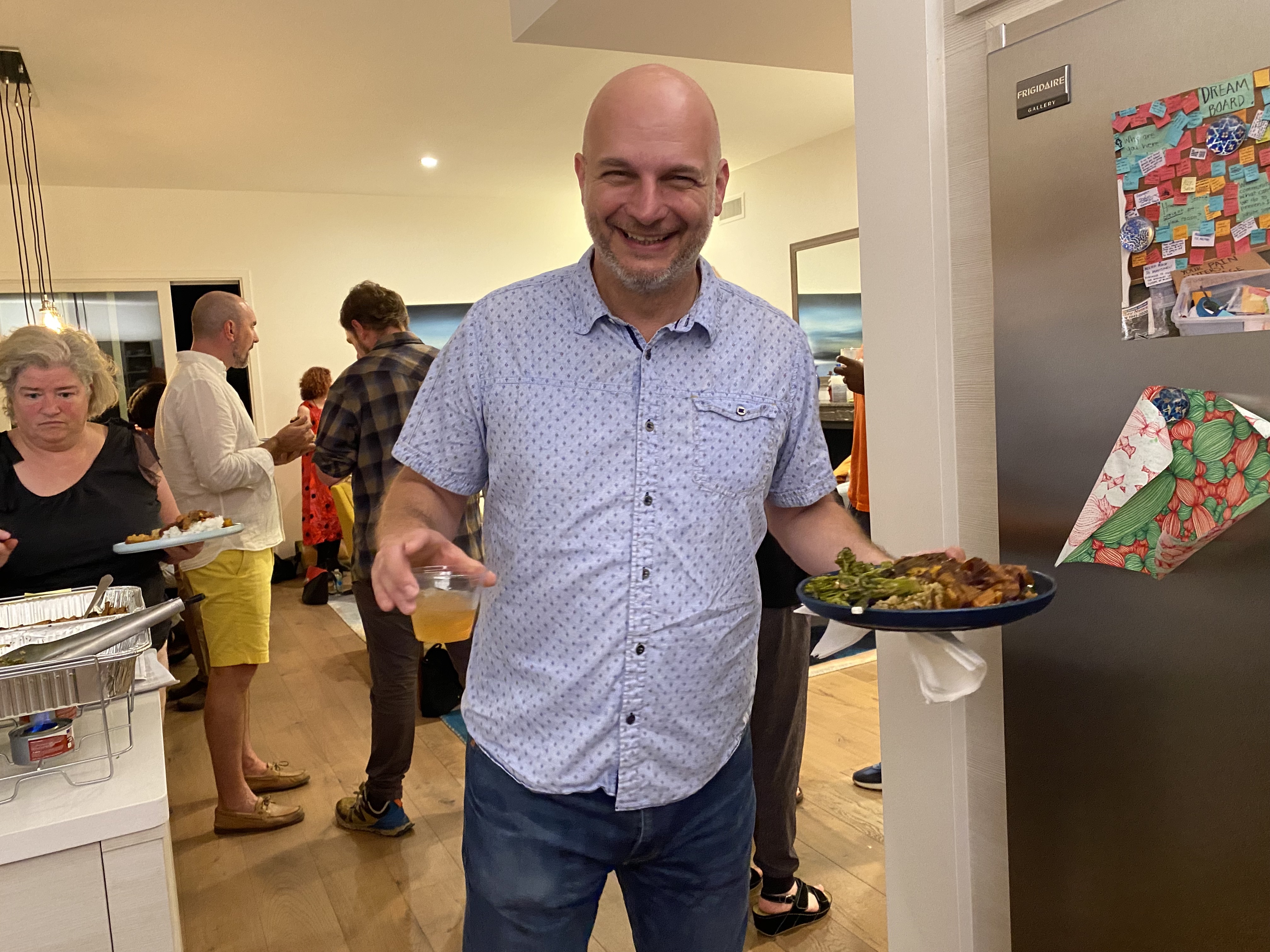 Gentleman holding a plate of food.