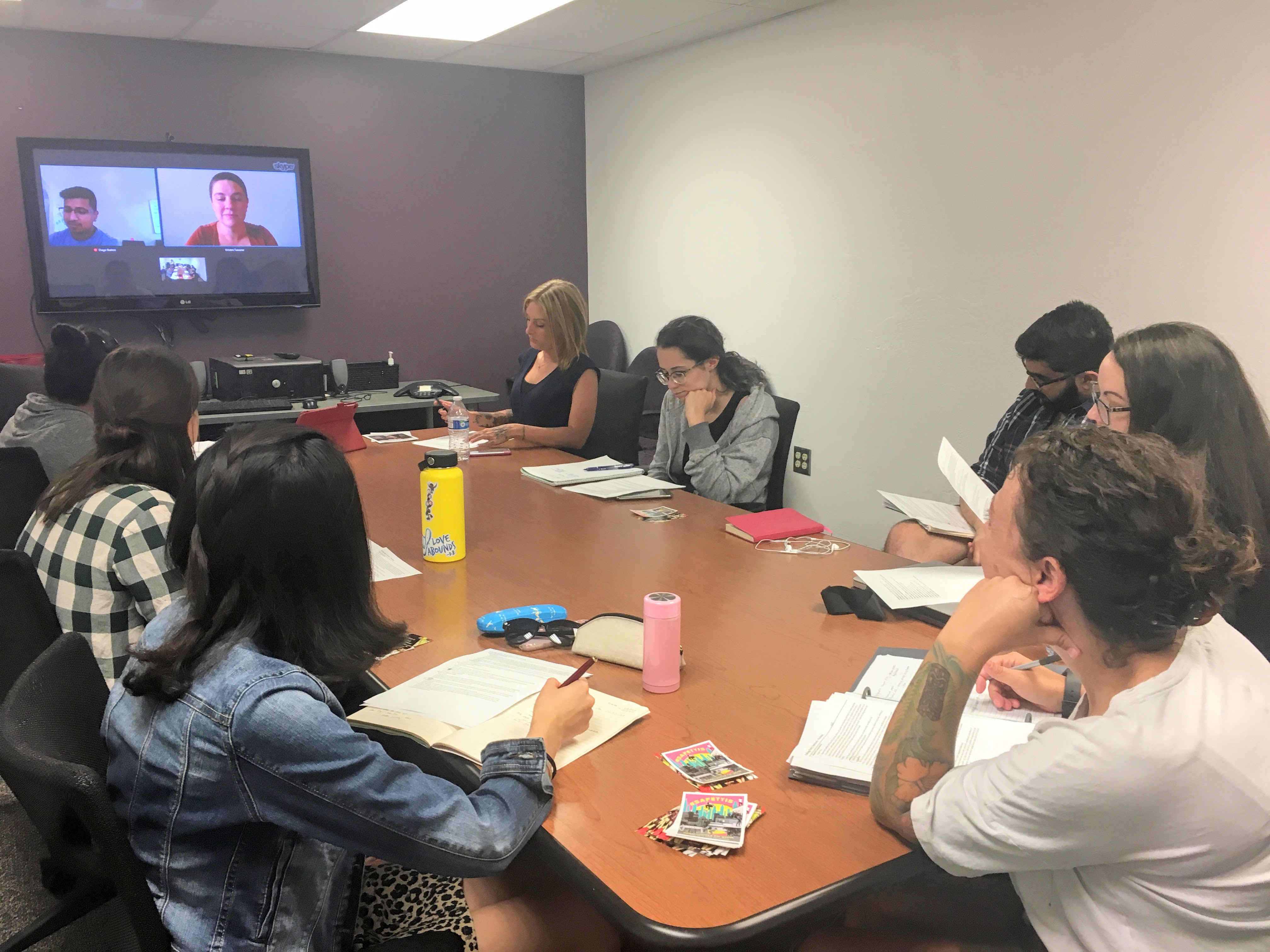 A group of CCI fellows sit at a conference table.