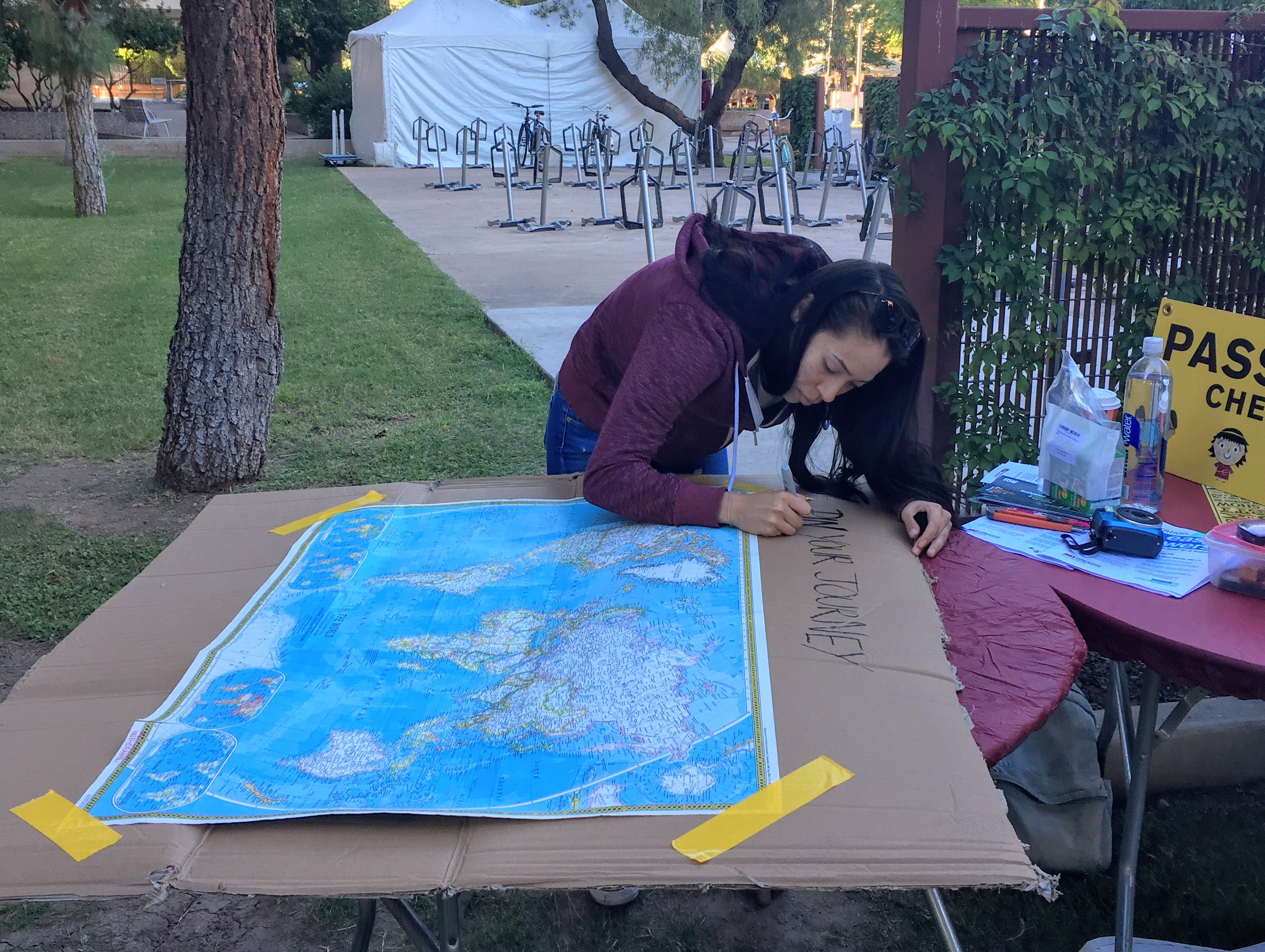 Woman writing on a map.