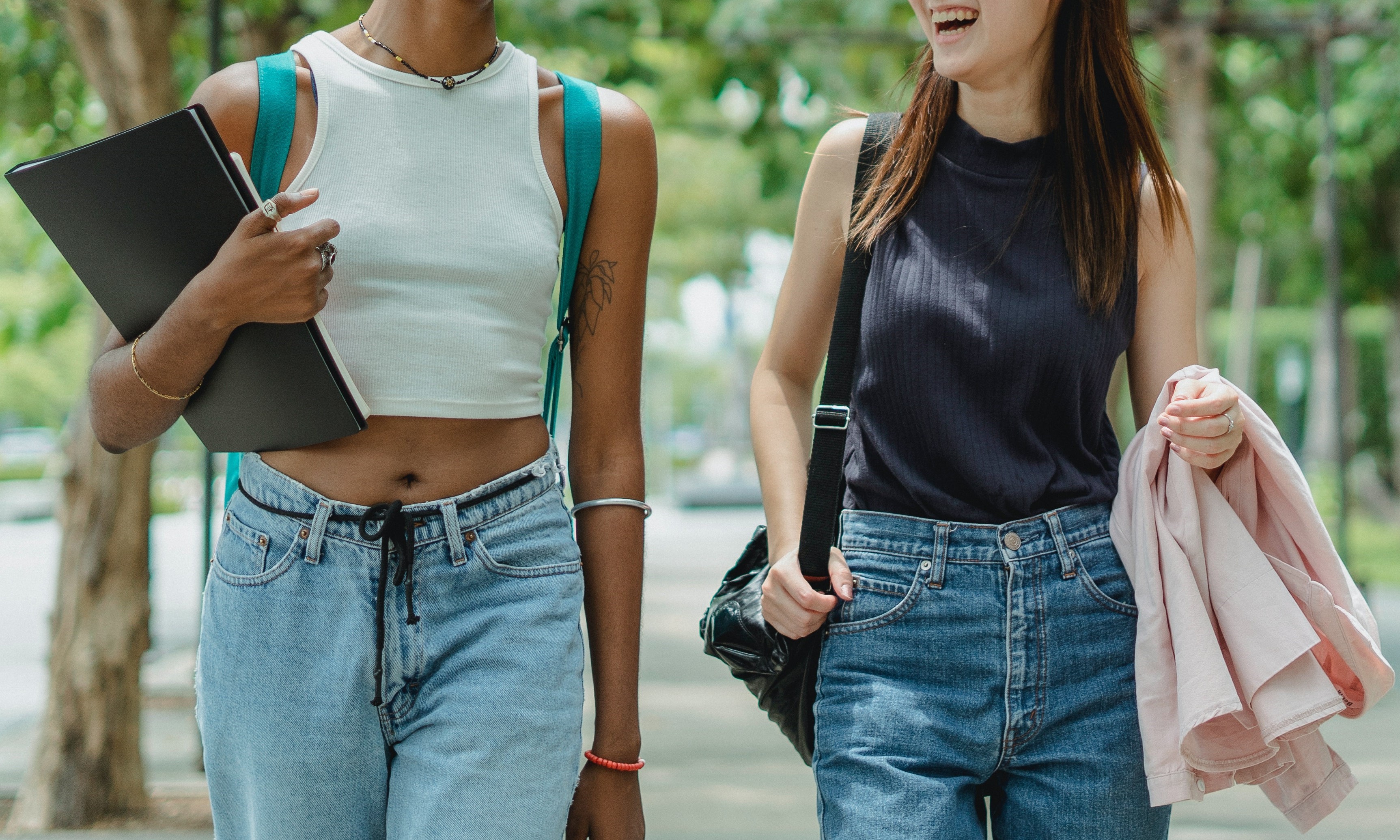 Two students walking side by side on campus.