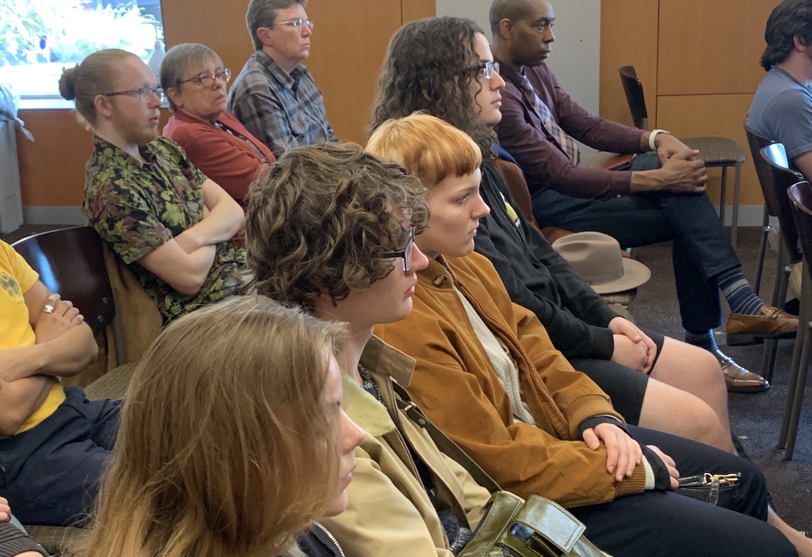 a crowd, seated and facing right.