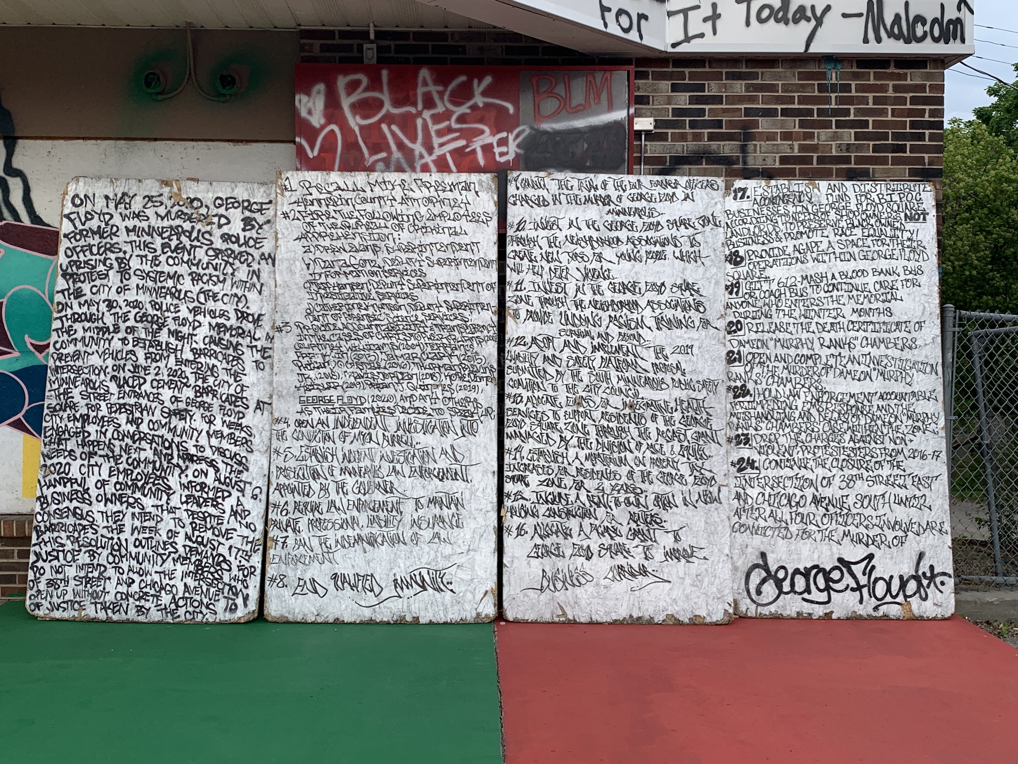 24 demands written on four large sheets of plywood