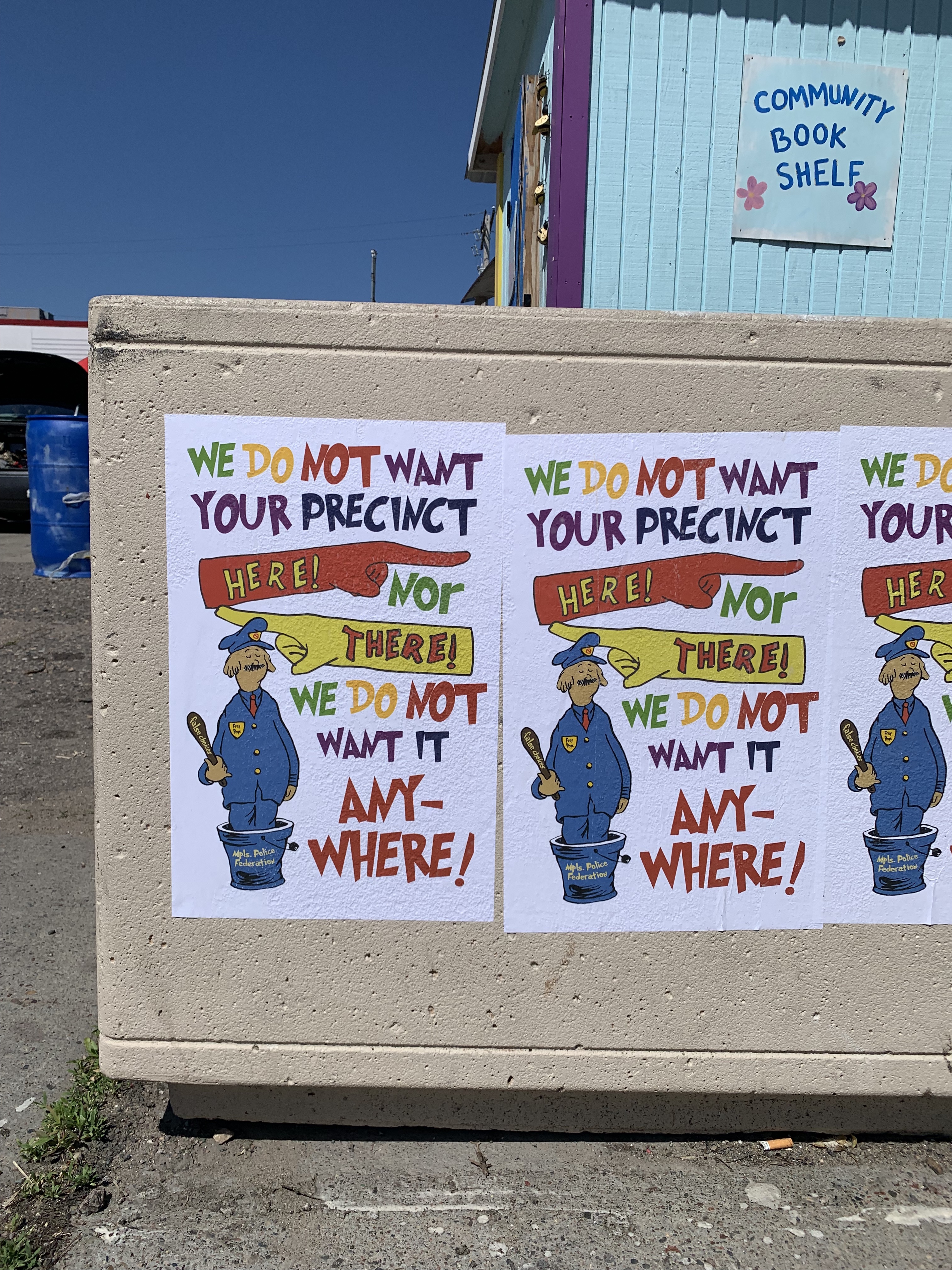 Posters reading: "We do not want your precinct here! Nor there! We do not want it any-where!"