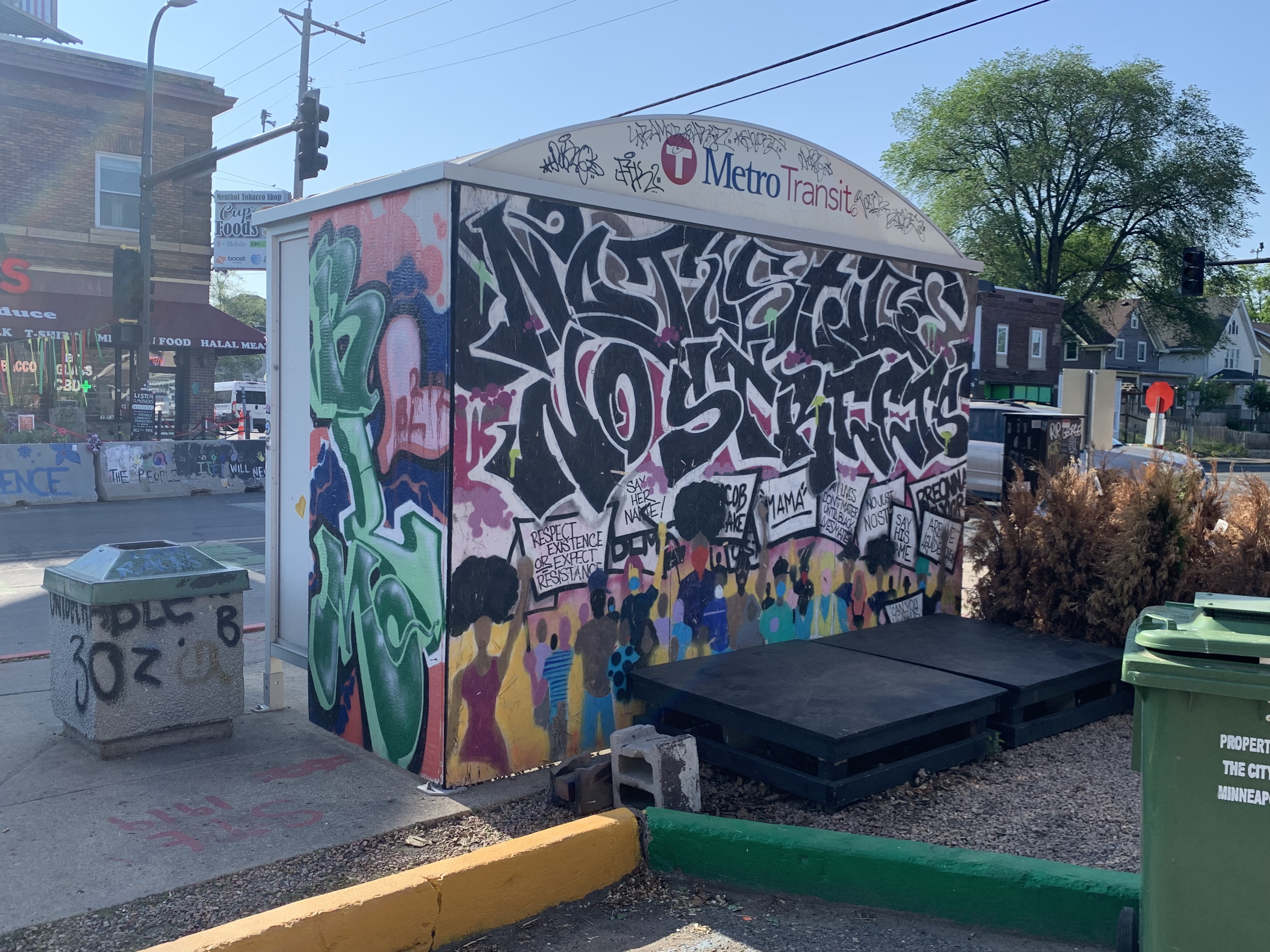 "No justice no streets" written on a bus shelter
