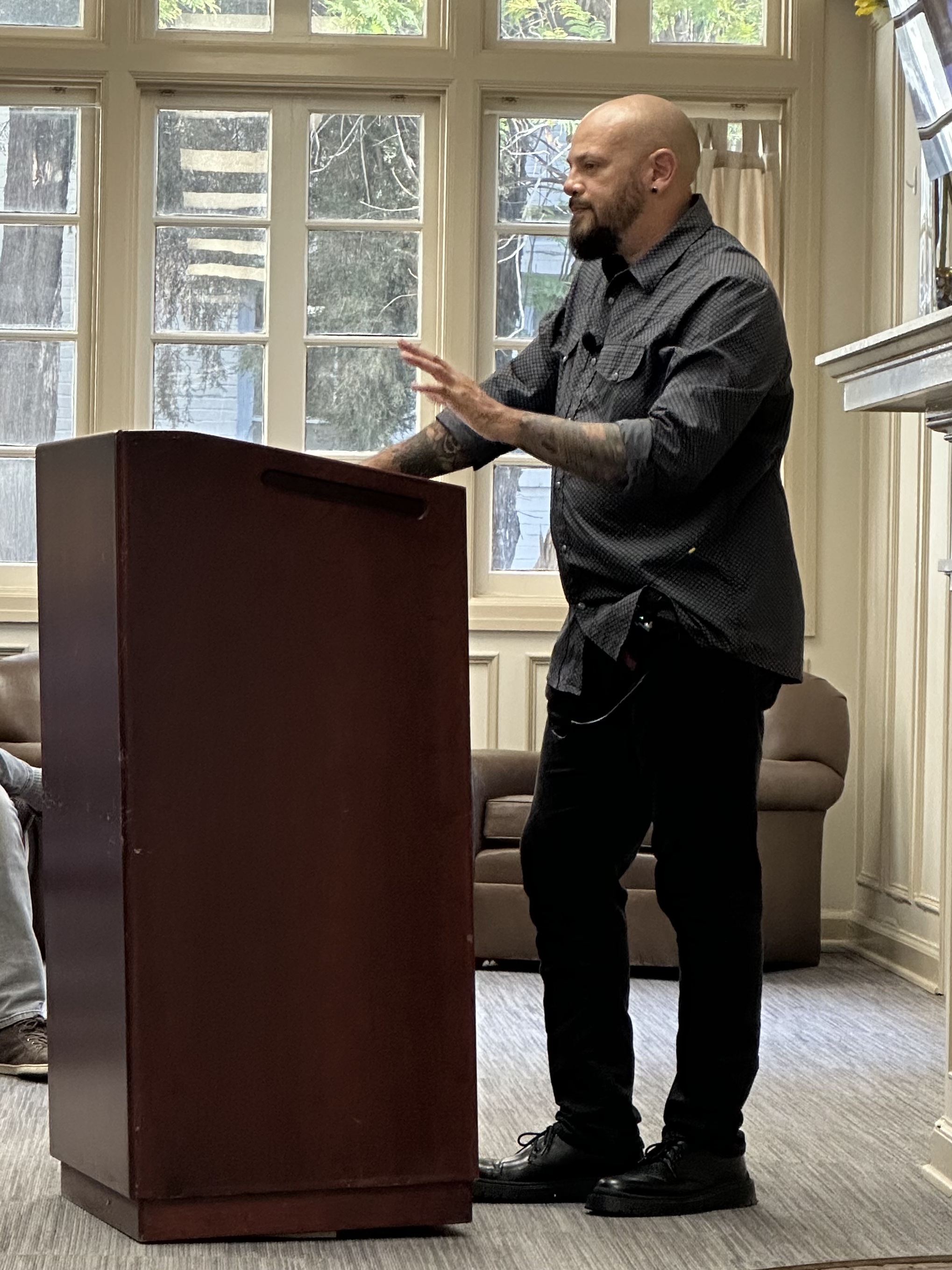 A man standing at a podium, addressing a crowd.