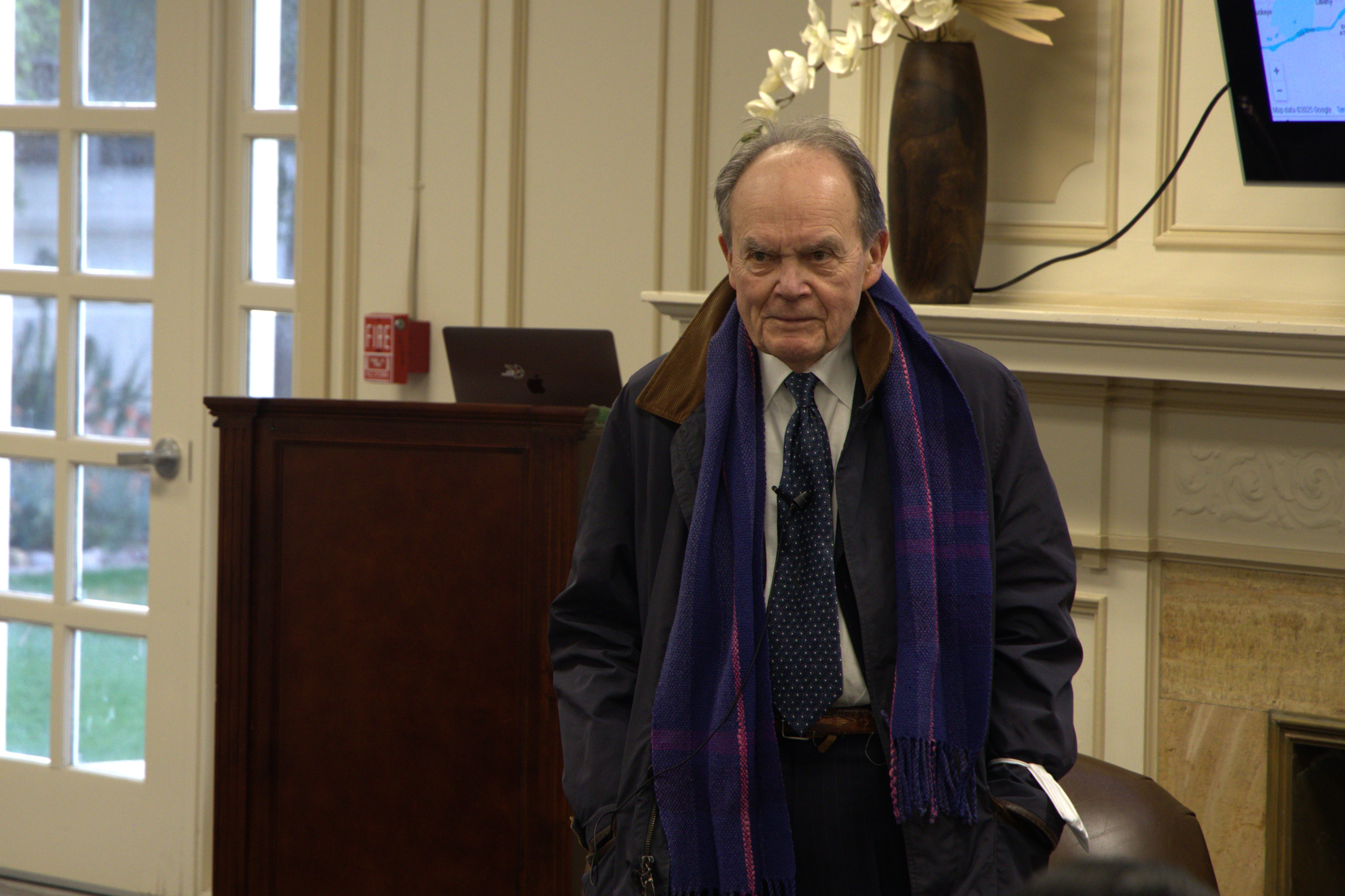 John Womack stands in front of audience answering questions